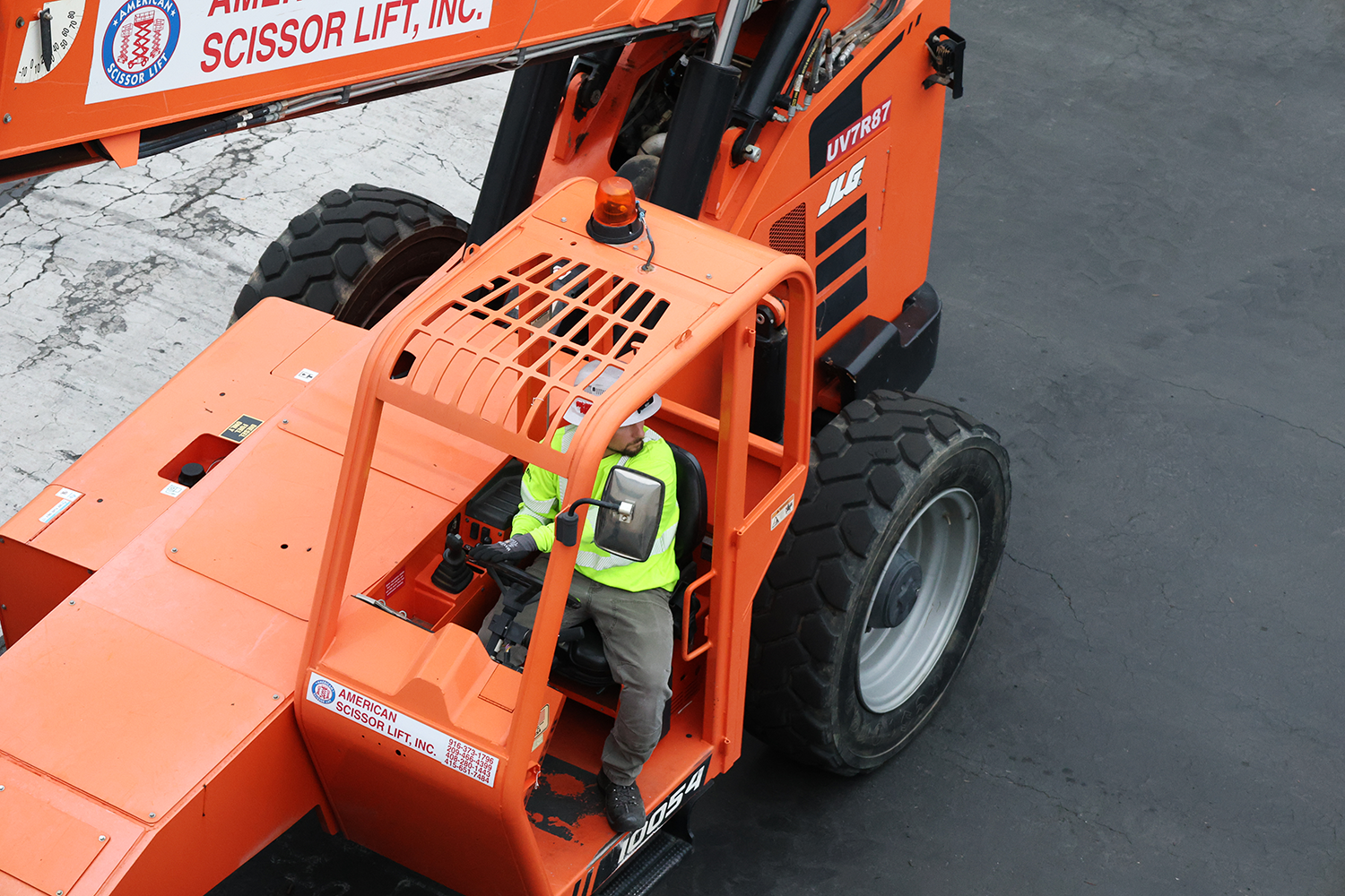 Truckee Meadows Electric Employee Driving Scissor Lift